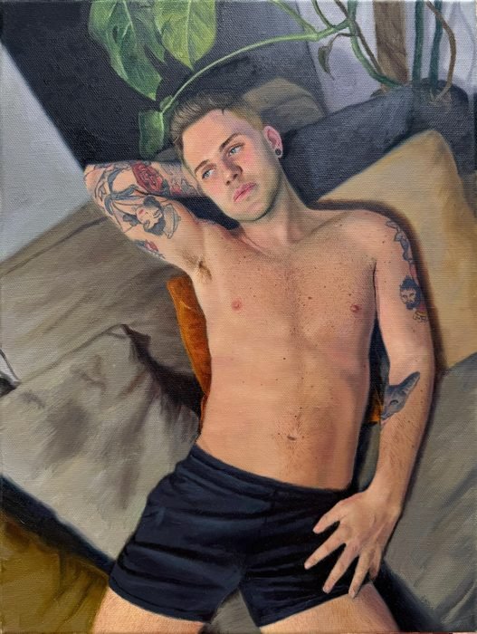 Oil painting of a tattooed young man lying back on cushions beneath a trailing plant