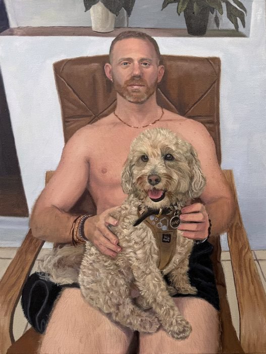 Oil portrait of Anthony in a leather chair holding Natty, a cream cockapoo