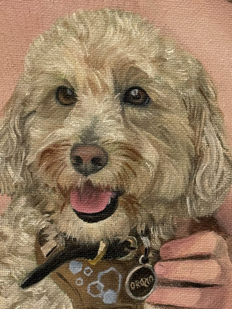 Close-up of Natty’s finished face, tongue out, with her name tag