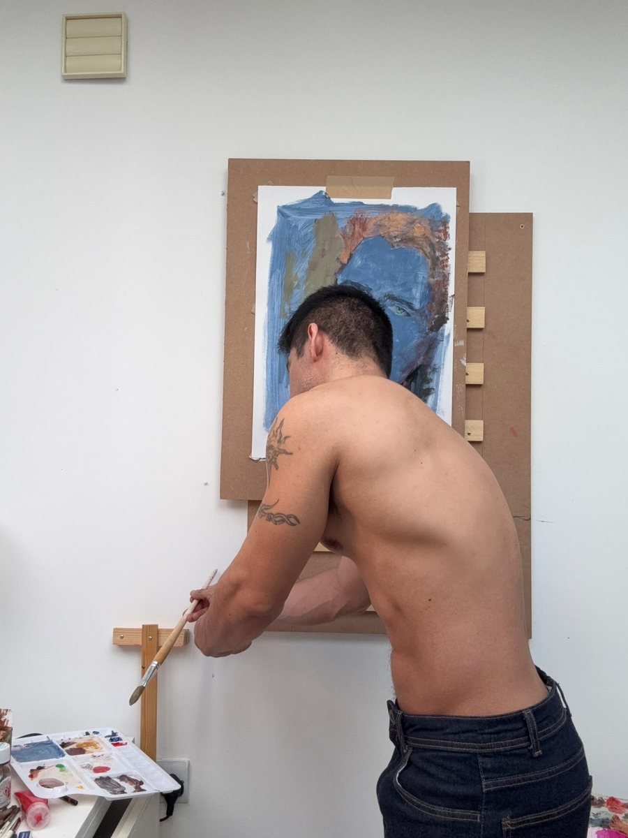 Dante leaning in to work on the blue portrait